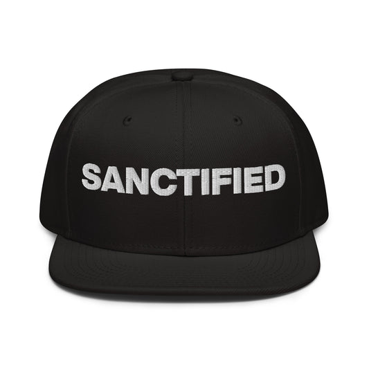 Christ Centered Faith unisex Christian snapback hat with "Sanctified" text embroidered in white on black background.