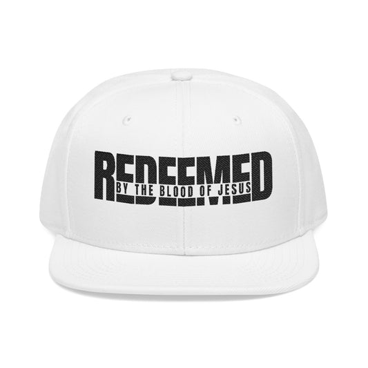 Christ Centered Faith unisex Christian snapback hat with "Redeemed By The Blood Of Jesus" text embroidered in black on white background.