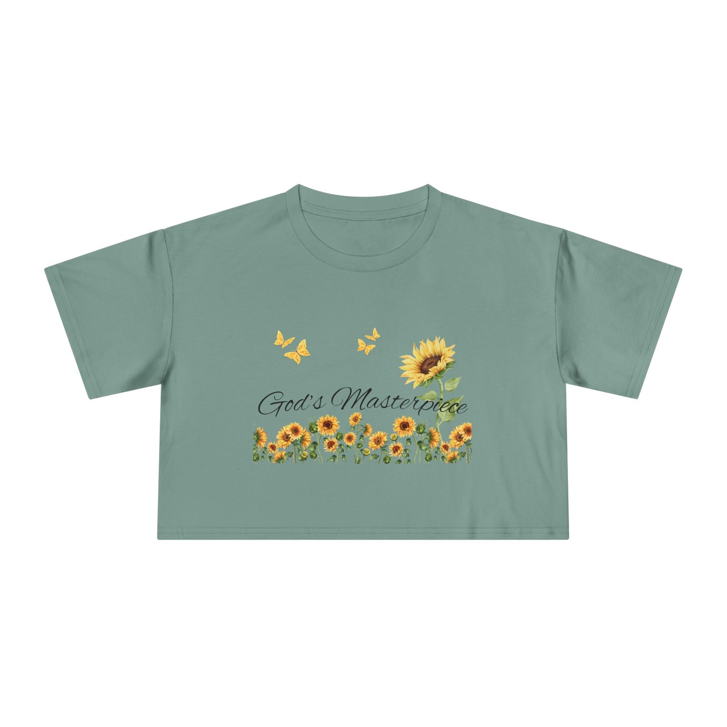 Christ Centered Faith women's cropped Christian t-shirt with "God's Masterpiece" text in black surrounded by sunflowers and yellow butterflies on green background.