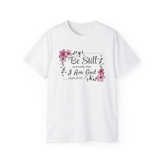 Christ Centered Faith women's Christian t-shirt with "Be Still And Know That I Am God" and Psalm 46:10 Bible Verse text in black with pink flowers and green vine on white background.