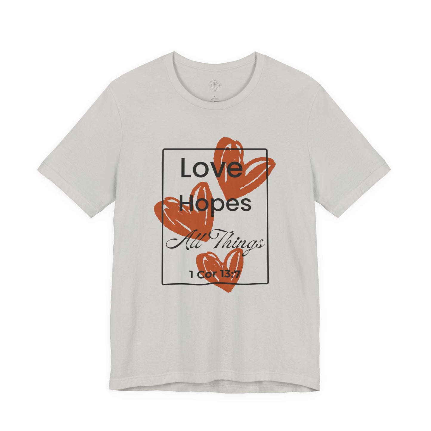 Christ Centered Faith women's Christian t-shirt with "Love Hopes All Things" and 1 Corinthians 13:7 Bible verse text in black over red hearts inside a black rectangle outline on gray background.