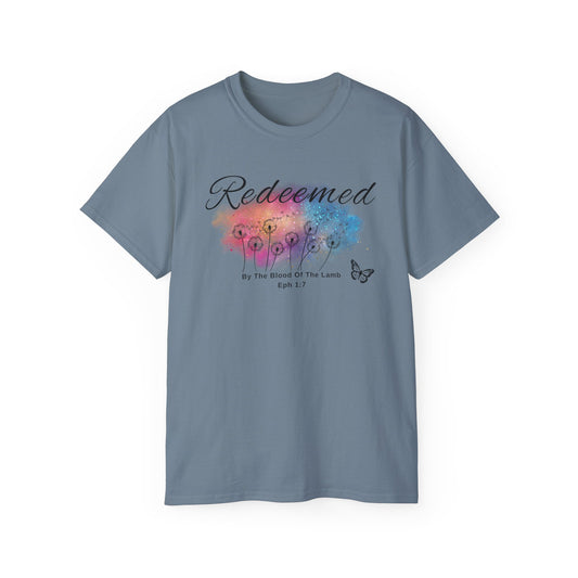 Christ Centered Faith women's Christian T-shirt with "Redeemed By The Blood Of The Lamb" and Ephesians 1:7 Bible verse text in black over a multicolor watercolor mark with black butterfly and dandelions on stone blue background.
